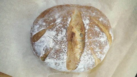 Putting baked bread on the grill overhead Stock Footage 121120271