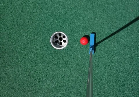 Putting the ball on a mini golf course Stock Photos