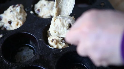 Putting batter in muffin pan Stock Footage 102750331
