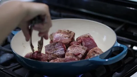 Putting beef into a cast iron pan, cooking, 4k, real time Stock Footage 252166766