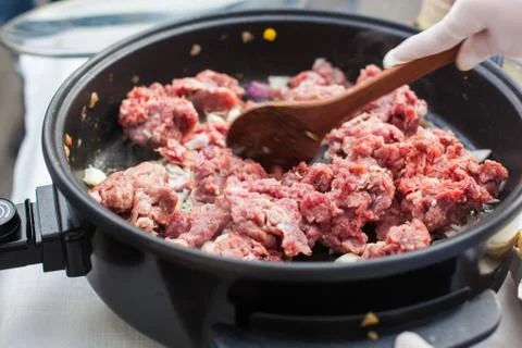 Putting beef meat in the pan Stock Photos