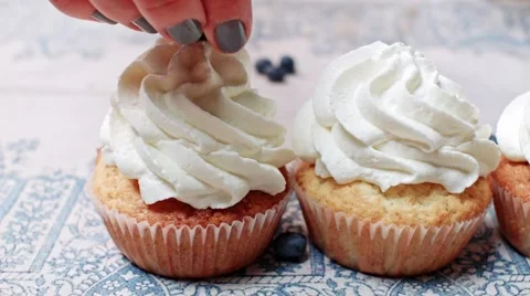 Putting berries on top of cupcakes Stock Footage 68020002