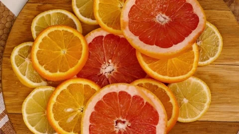 Putting a big piece of grapefruit with my hands Stock Footage 233620712