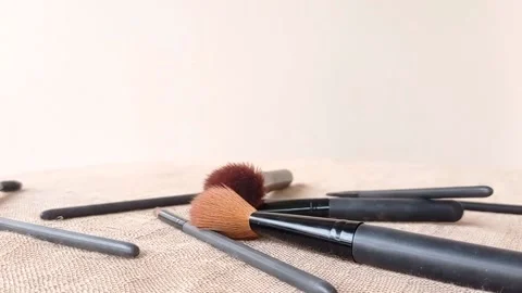 Putting the black brushs on the brown table Stock Footage 146253211