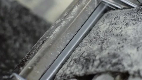 Putting black dough in pasta machine and rolling it closeup Stock Footage 138942931