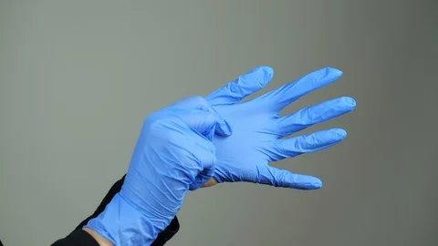 Putting on blue rubber hand gloves Video stock 127626137
