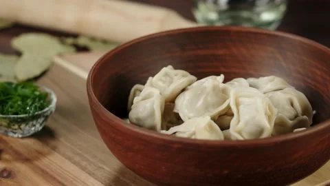 Putting boiled dumplings on board close-up, cooking dough products with meat Stock Footage 159005559