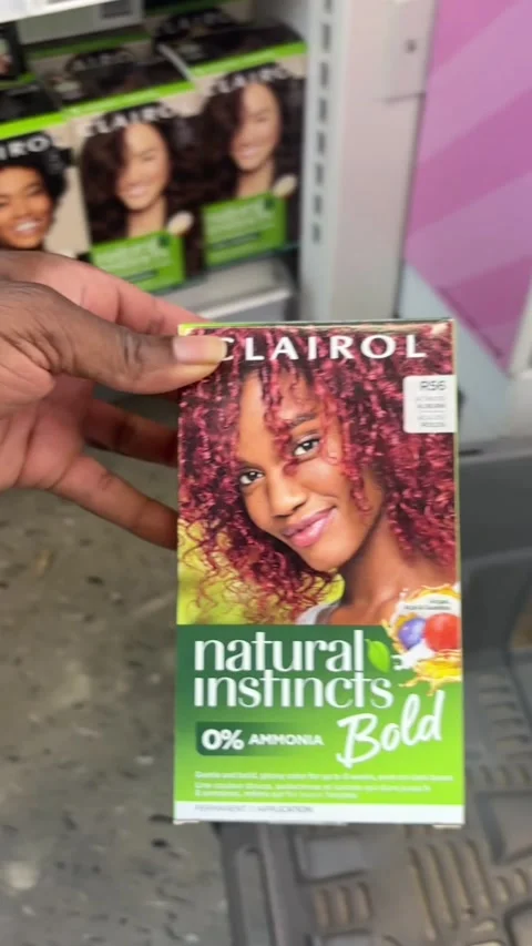 Putting a box of Clairol Bold Natural Instincts in a shopping basket 스톡 동영상 334963009