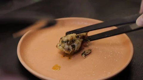 Putting braised chicken onto plate Stock Footage 121119281