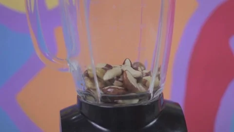 Putting brazil nuts on a blender with style! Stock Footage 79537097