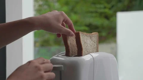 Putting bread into the bread toaster Stock Footage 171447337