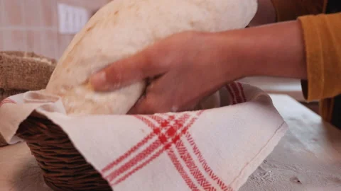 Putting the bread dough into leavening basket - closeup Video stock 131699983
