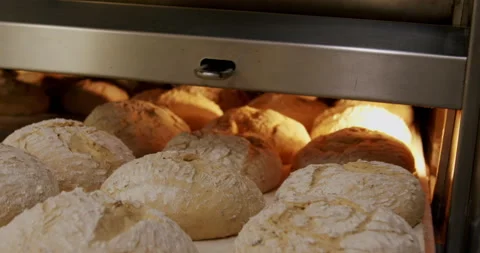 Putting bread in the oven at a bakery 4K. Video stock 221565510