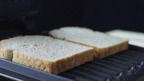 Putting bread in toaster and closing it Stock Footage 130060662