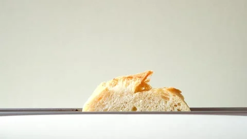 Putting bread in the toaster for breakfast in the morning Stock Footage 292937186