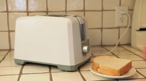 Putting bread into the toaster Stock Footage 944010