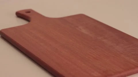 Putting a bread in a wood board Stock Footage 133816035