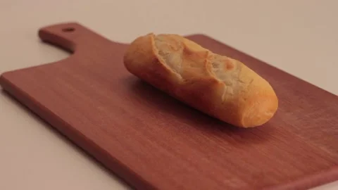 Putting a bread in a wood board Stock Footage 133816146