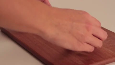 Putting a bread in a wood board Stock Footage 133816171