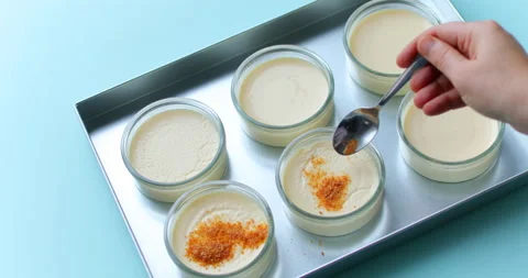 Putting brown sugar on the top of creme brulee Stock-Footage 123611264
