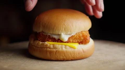 Putting Bun On Fried Fish Burger Spread With Mayonnaise And Cheese. Stock Footage 276836693