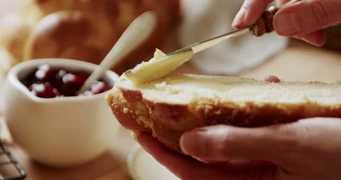 Putting butter on bread, breakfast close-up in 4K. Stock Footage 221569353