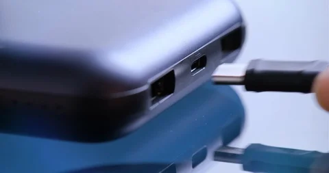 Putting cable into power bank. Stockbeeldmateriaal 102040122