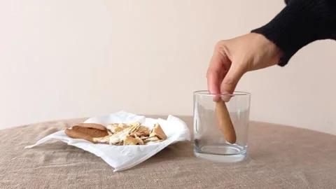 Putting the cake into a cup on a brown table Stock Footage 145672696
