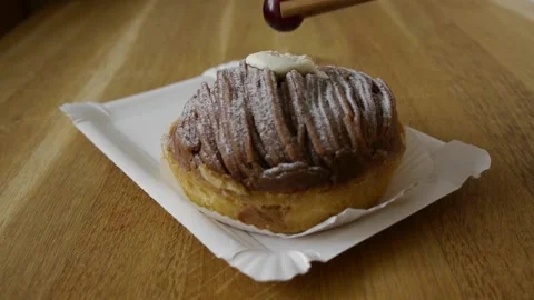 Putting a candy cherry on top of a cake gourmet decoration Video stock 155972110