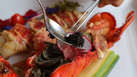 Putting the caviar on black spaghetti. Stock Footage 124681882
