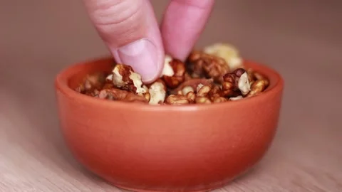 Putting ceramic pot with walnuts on the table 動画素材 81584407