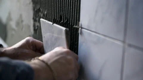 Putting ceramic tile on the wall Stock Footage 39385883