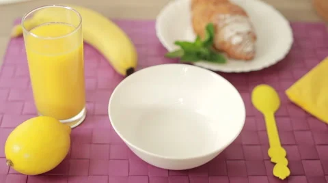 Putting cereal into a bowl at breakfast Stock Footage 59603540