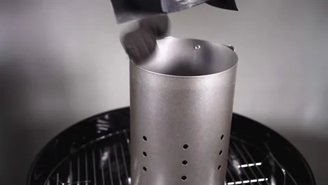 Putting Charcoal into  starter  of  grill Stock Footage 145845008