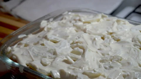 Putting the cheese into baking try Stock Footage 86046656