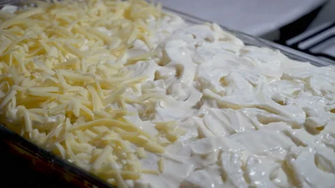 Putting the cheese into baking try Stock Footage 86060953