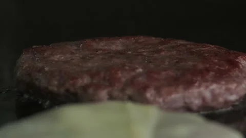 Putting cheese on burger while it is frying Stock Footage 140328638