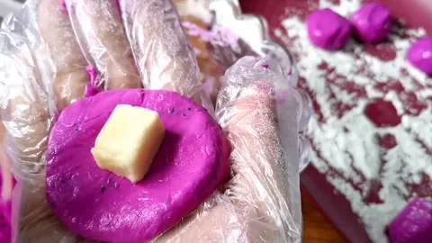 Putting Cheese inside the Glutinous Rice Balls Stock Footage 149408290