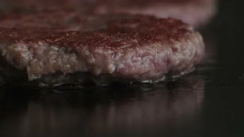 Putting cheese on meat for burger Stock Footage 140328726