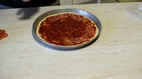 Putting cheese on pizza Stock Footage 76998059