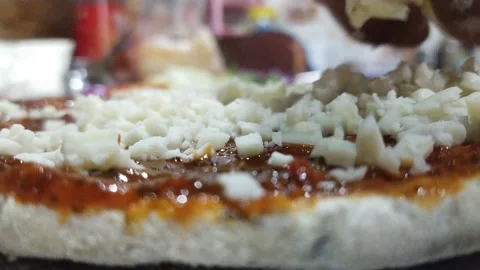 Putting cheese on pizza preparation Stock Footage 238757551