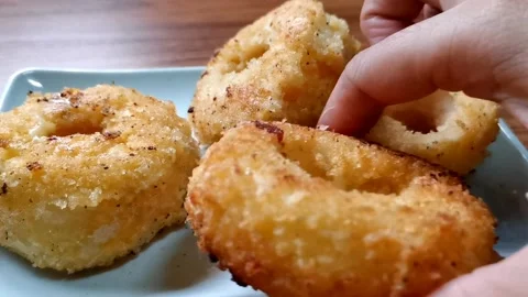 Putting Cheesy Onion Rings on a Serving Plate Stock Footage 149408005