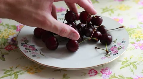 Putting cherry on a plate Stock Footage 64623058