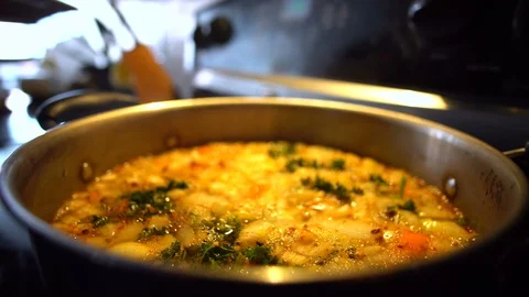 Putting Chicken into Boiling Soup Pot Stock Footage 89970297