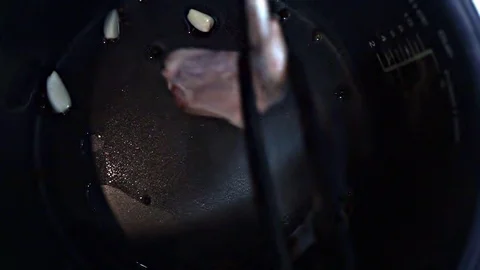 Putting chicken into pan Stock Footage 101967120