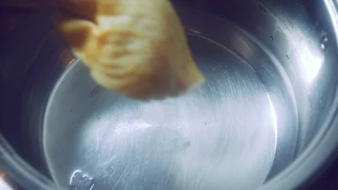 Putting chicken in a pot of boiling broth Stock Footage 97226437