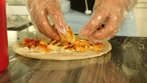 Putting chicken on shawarma Stock Footage 145789642