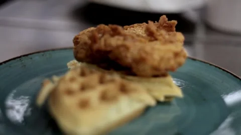 Putting chicken on top of a waffle Stock Footage 307340036