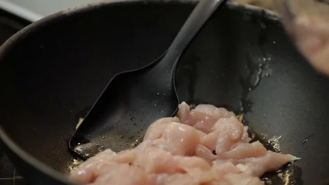 Putting chicken into wok Stock Footage 98361522