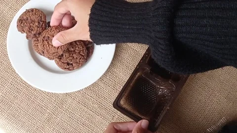 Putting the chocolate biscuits into the brown box Stock Footage 150398830